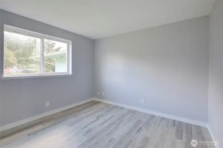 Bedroom Two - Comfortable and bright downstairs bedroom, perfect for guests, a home office, or a cozy retreat. Features a large window that fills the space with natural light and a convenient layout that blends seamlessly with the main living areas