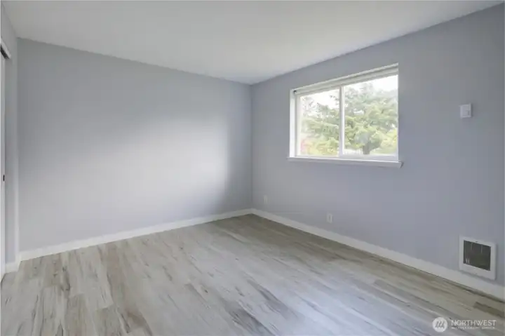 Bedroom One - Comfortable and bright downstairs bedroom, perfect for guests, a home office, or a cozy retreat. Features a large window that fills the space with natural light and a convenient layout that blends seamlessly with the main living areas