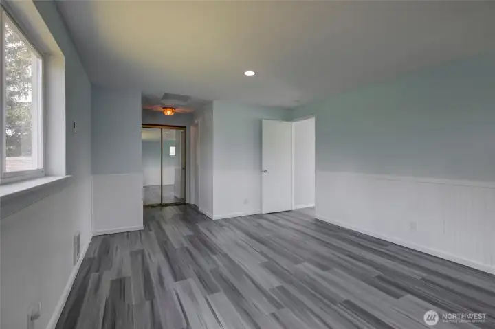 Light-filled primary bedroom with soft neutral tones, a spacious layout, and a calm, relaxing feel.