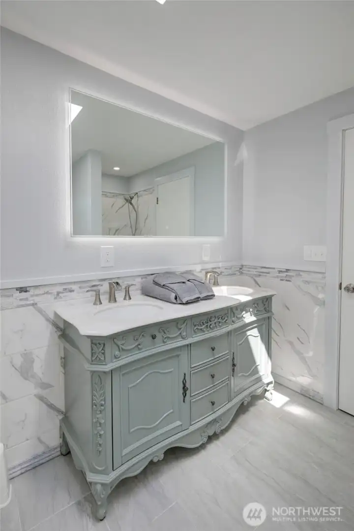 Light-filled primary bathroom with a soaking tub and separate walk-in shower—designed for both relaxation and everyday ease.