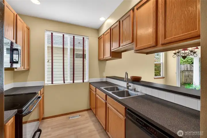 Kitchen with breakfast bar keeps you connected, ideal for casual meals or entertaining.