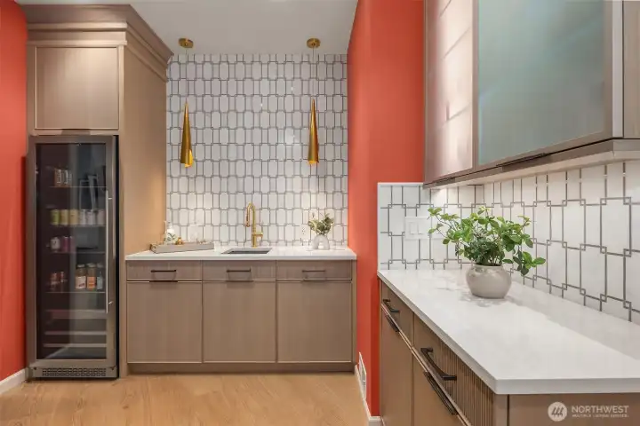 Beautifully renovated wet bar featuring a built-in beverage fridge.