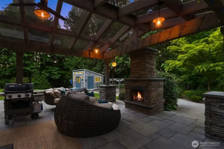 Skylight-covered patio with a gas fireplace allows year-round enjoyment—protected from the rain while still embracing the stunning views