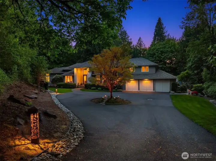 Ample space for guests in the driveway, complemented by a three-car garage with EV charger.