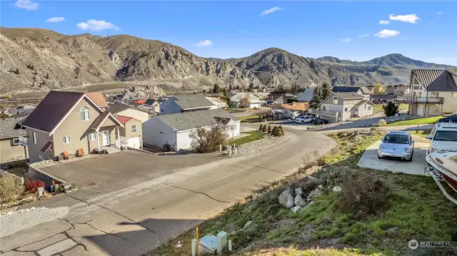 View from lot looking toward the northeast. Entiat Place is a quiet dead end street.  You can drive a golf cart from here to the private beach with all of its amenities!