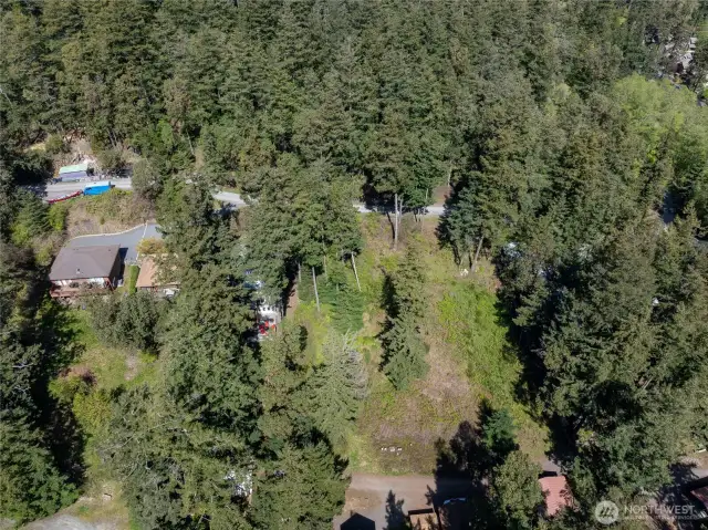 This .22 acre parcel lies immediately to the right of the homes in the photograph. The lot does not comprise the entire vacant area visible in this photo.