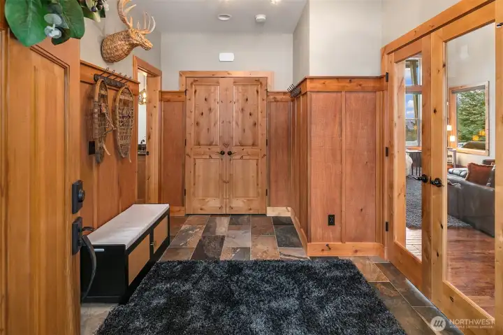 Functional foyer with numerous hooks and storage closet serves as your mudroom and coat closet.  Lots of room for everyone coming in with snowy boots to hang up the layers before entering the main area.