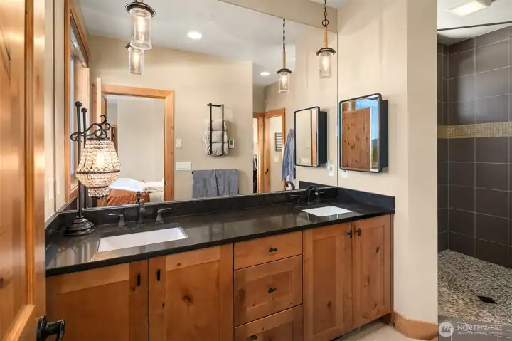 Primary bathroom has heated floors and walk-in smooth pebble floor shower.