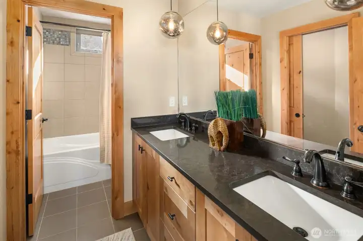 Upstairs bathroom with private toilet room, private shower/bath room and dual sinks with lots of cabinet storage.