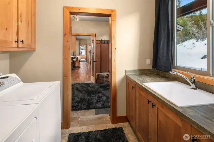 Utility Room with cabinets and sink. Washer and Dryer are included.