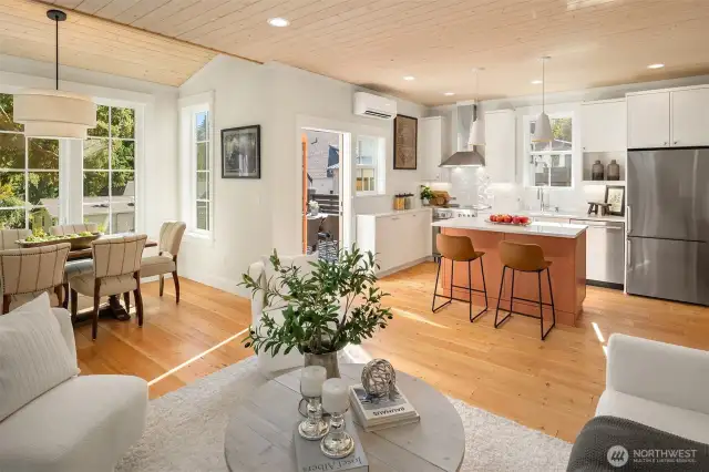 A gracious open floor plan provides comfortable living spaces warmed by the stained wood paneled ceilings.