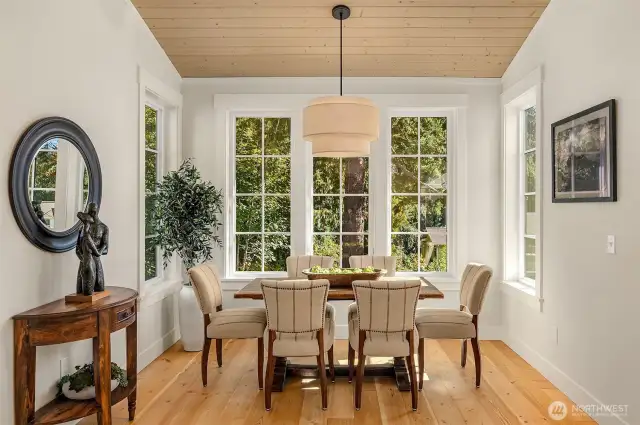 A stunning large dining room space overlooks the woodland and creek beyond.