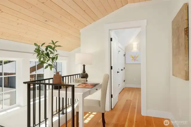 Explore the upstairs spaces and find a custom work space at the top of the stair landing.  Solid wood flooring graces the upstairs bedroom spaces.