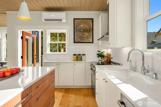 The kitchen looks over and steps out to the upper level dining terrace.  Dining al fresco anyone?