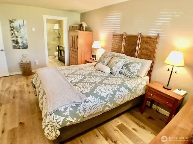 This inviting primary bedroom offers a serene retreat with an en-suite bath