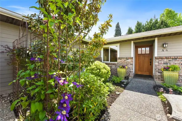Welcome home to this beautifully landscaped entryway that sets the tone for warmth and charm.