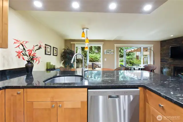 This photo captures the seamless connection between the kitchen and the home’s open living and dining areas