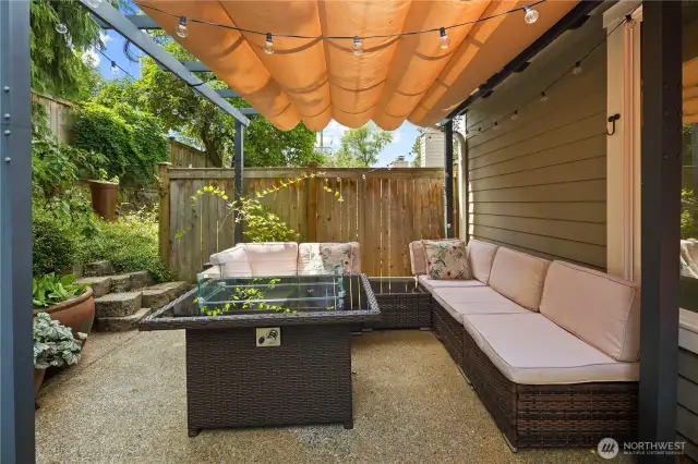 This enchanting backyard patio offers the perfect setting for evening relaxation.