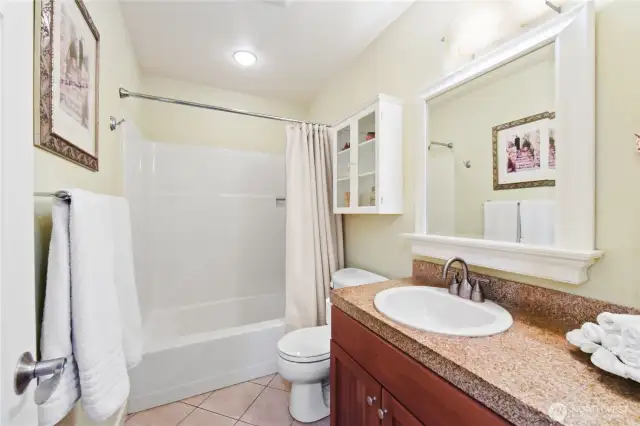 Main Bathroom. A large, framed mirror enhances the space