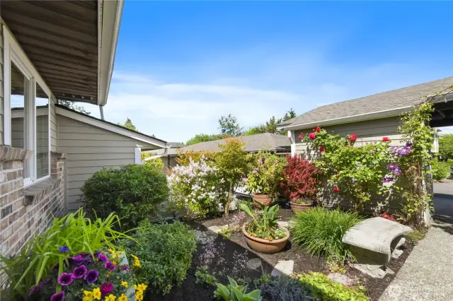 Vibrant seasonal flowers and tasteful architectural accents complete the picturesque setting.