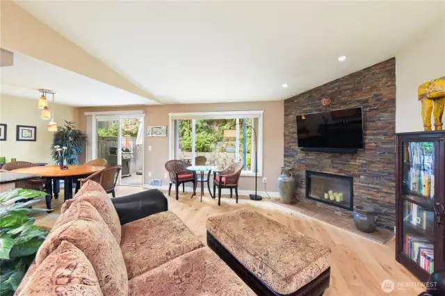 The focal point of the room is a striking floor-to-ceiling stacked stone fireplace