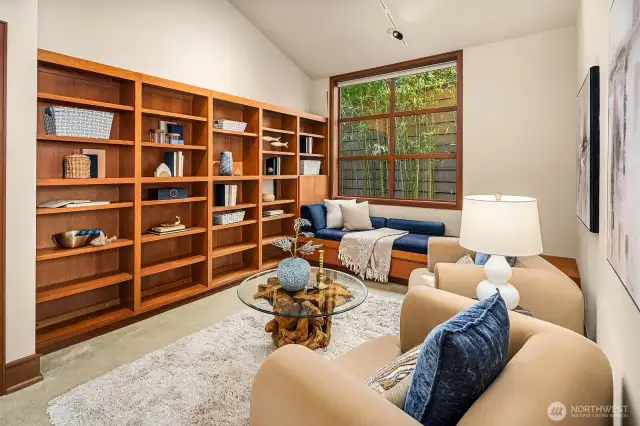 The library features built-ins and a cozy reading bench—easily convertible into a fifth bedroom if desired.