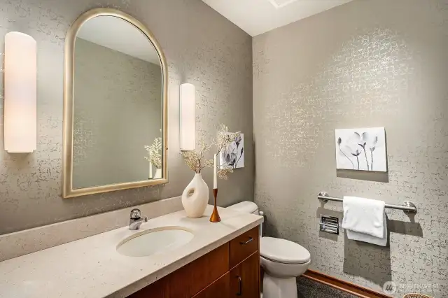 The main-floor bathroom exudes elegance, featuring solid wood cabinetry and refined finishes.