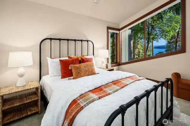 Bedroom #3, an en--suite, features a west-facing window that frames a spectacular view of the lake.