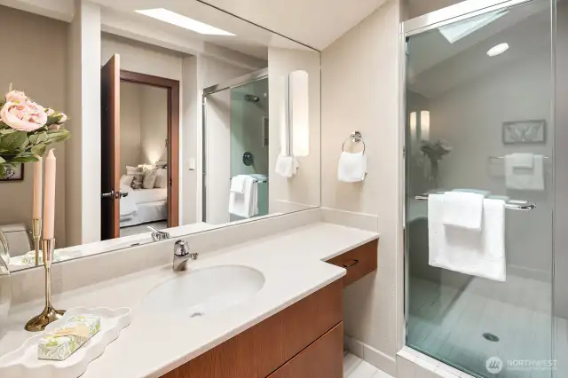 Bedroom #4 is also an en suite, featuring a private bathroom with a convenient step-in shower.