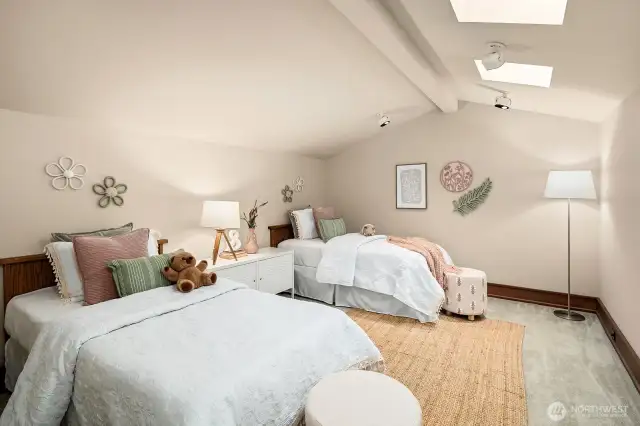 Adjoining Bedroom #4 is a flexible, nonconforming possible #5th bedroom that comfortably fits two twin beds and includes a spacious walk-in closet.