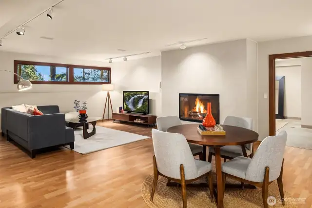 The daylight basement offers a cozy gas fireplace and plenty of space for TV, media, and game nights.