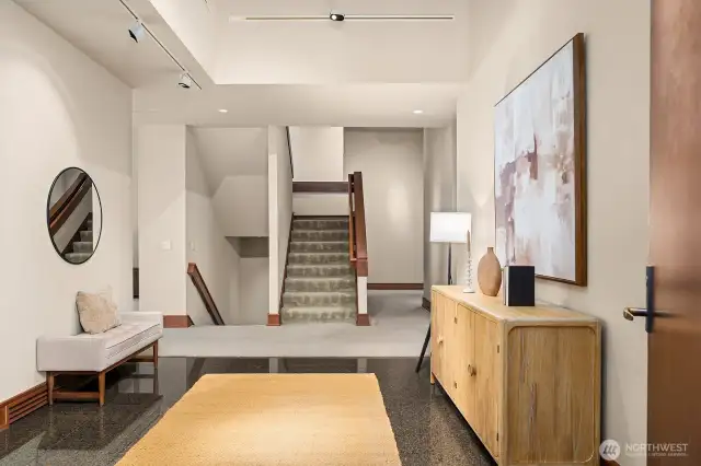 From the front door, step into a spacious entry with soaring ceilings and a gallery-like ambiance.