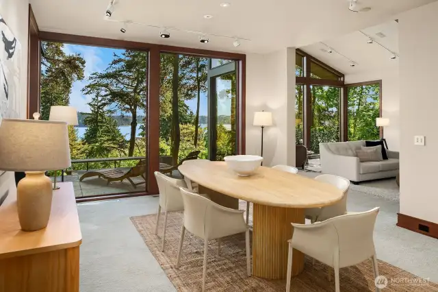 The dining room comfortably seats 12 or more and includes a wet bar along the back wall. With a sunset view and filtered light, it's perfect for entertaining.