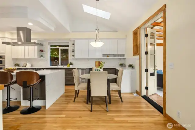 Updated kitchen featuring a sleek waterfall granite island and modern finishes