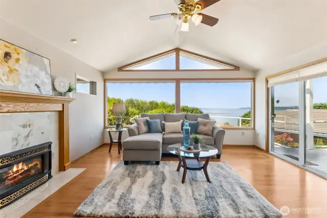 Lovely Gas fireplace to cozy up those winter days, Massive windows with slider out to the deck, Daylight & views abound!