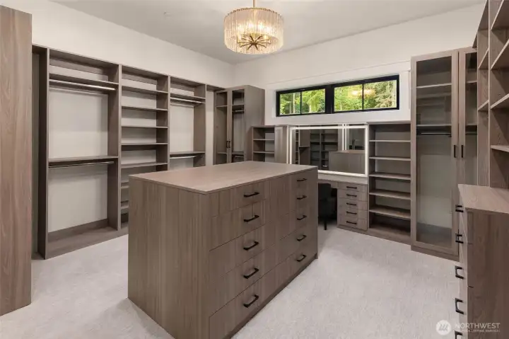 massive primary closet with built in vanity and lighted mirror.