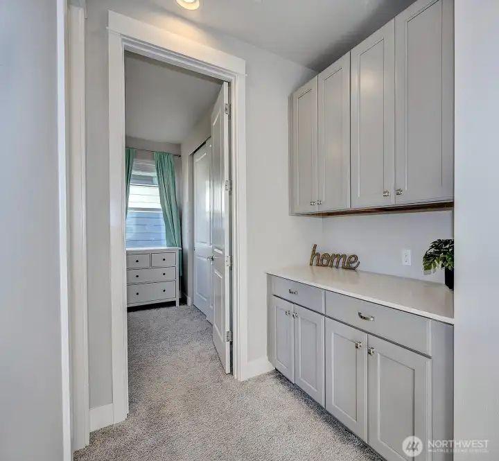 Built-in cabinetry and counter space in the hallway close to the upstairs bedrooms