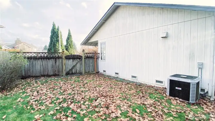 Side yard with heat pump.