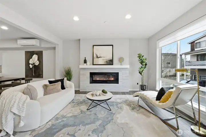 The living room features large west-facing windows that capture the glow of the setting sun.