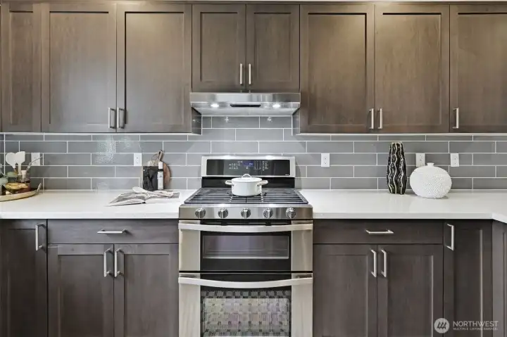 Double ovens and a gas cooktop simplify meal preparation.