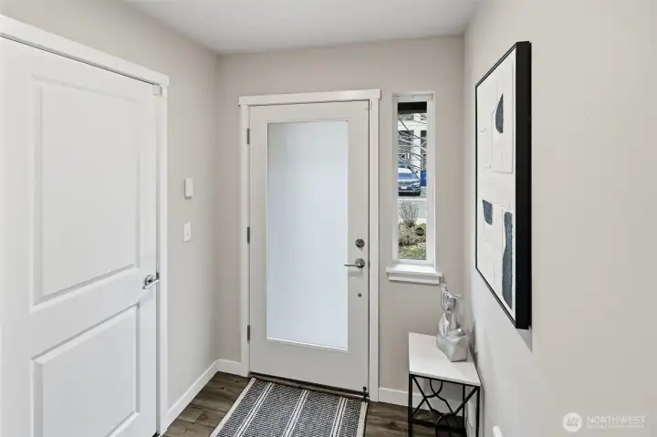 Entryway and the garage is accessed from the door on the left.