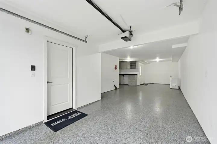 Workbench or storage space in addition to space for 2 cars. The chest freezer stays with the home.