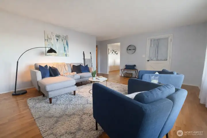 Another view of your spacious living room, fireplace is behind you here, you are facing towards front door and dining room area.