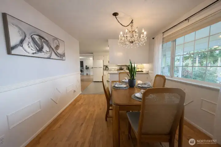 Lots of room for company in this dining room, adjacent to the kitchen and living room