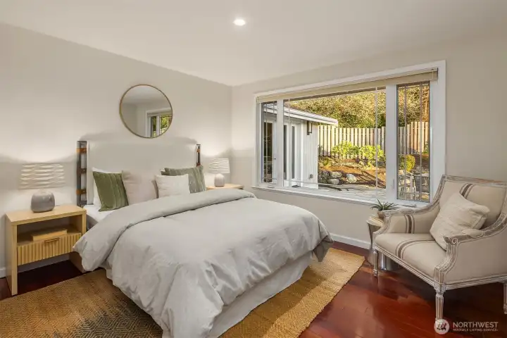 This bedroom could be an office or guest room and looks out on the stunning view of the back garden and waterfall