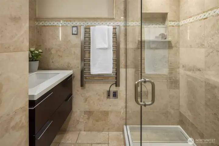 Fully remodeled lower level bathroom is stylish with step in shower too.