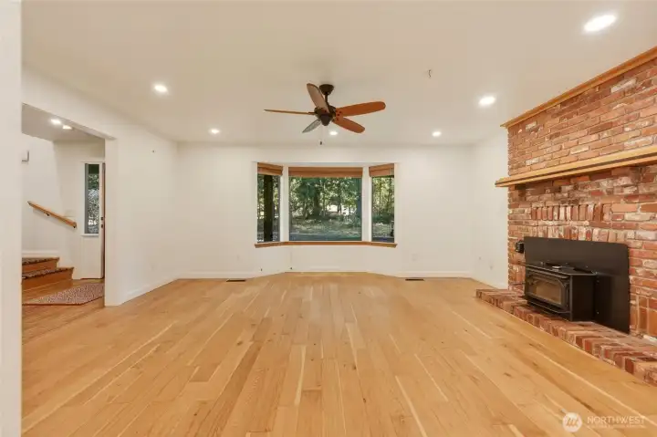 Large Living Room with Engineered hardwood floors and wood fireplace