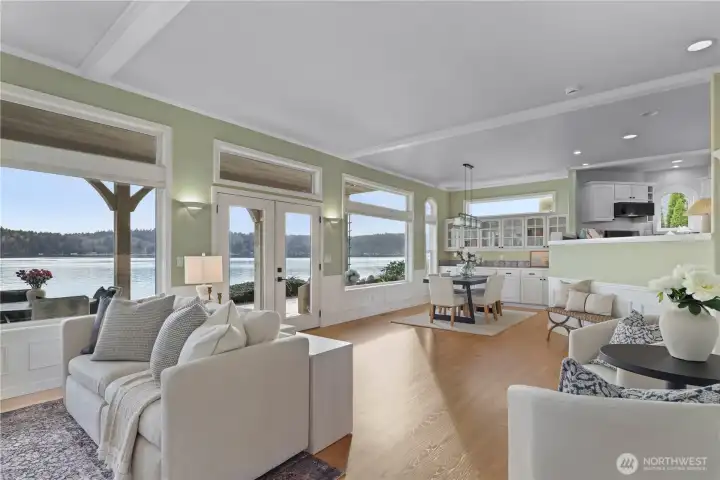 Open-concept living and dining space designed for comfort and connection, with abundant natural light and stunning water views throughout.