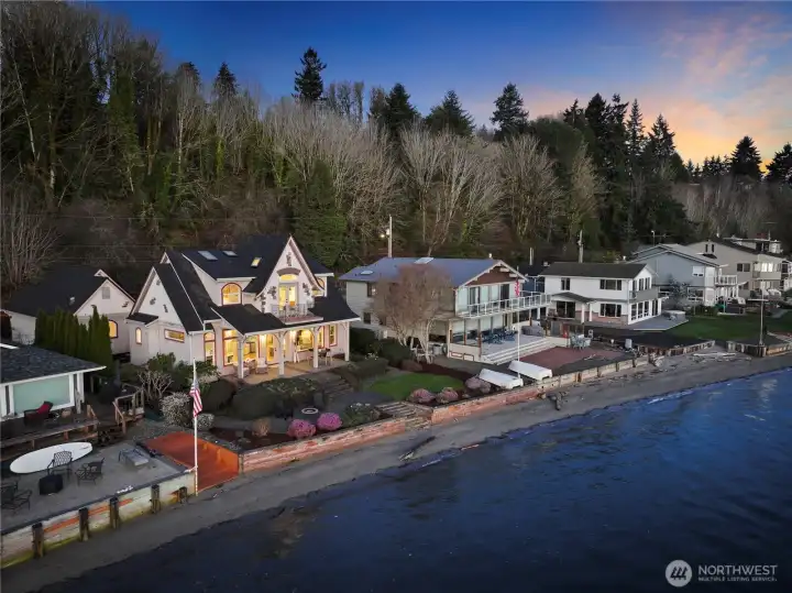 Spectacular aerial view showcasing the home’s prime waterfront setting, private shoreline, and beautifully designed outdoor spaces.
