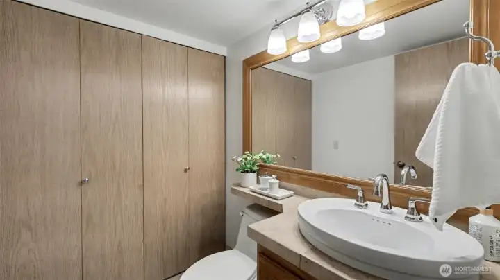 The 1st floor 1/2 bath has been combined with the laundry closet with the washer and dryer remaining.